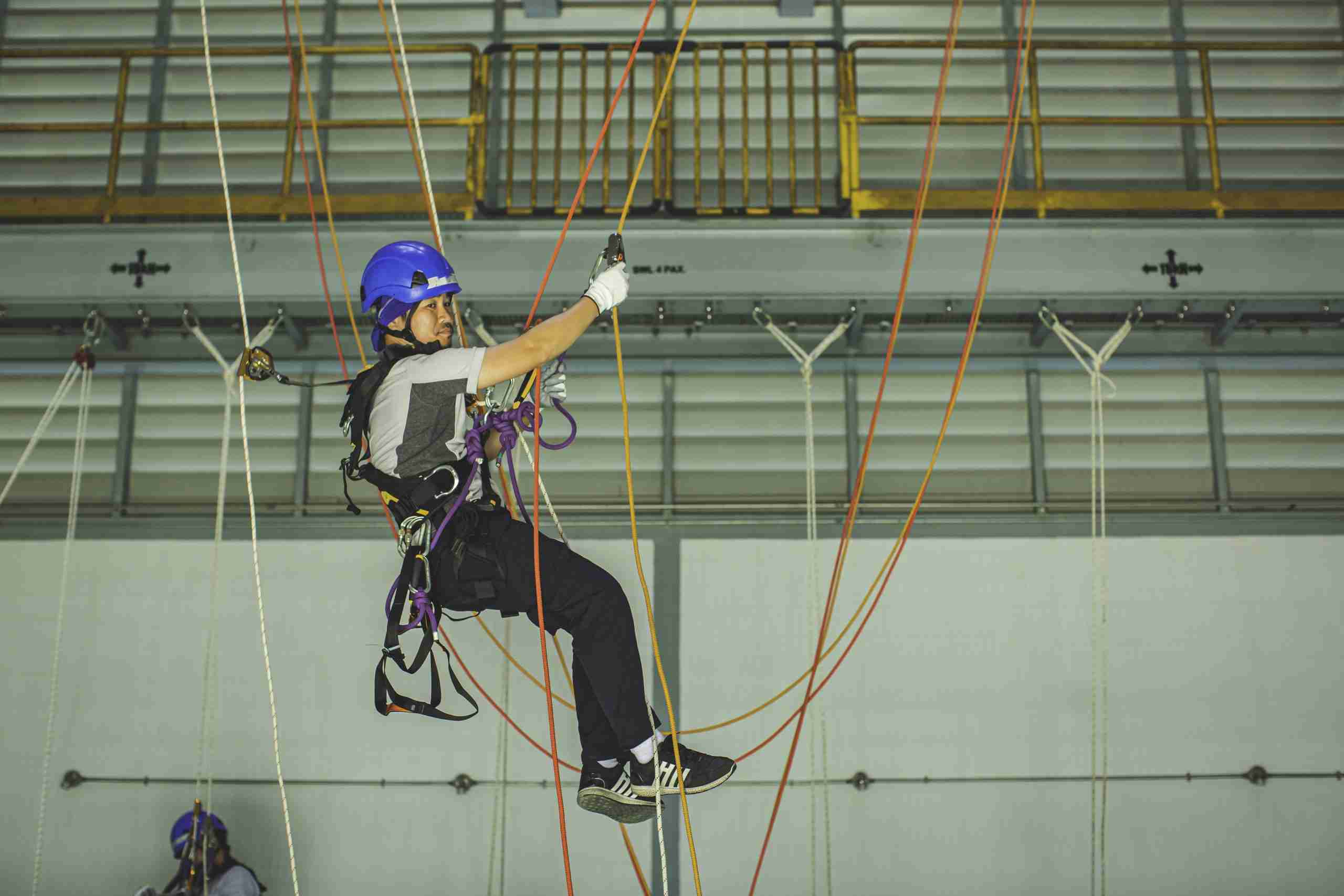 Male worker training rope access